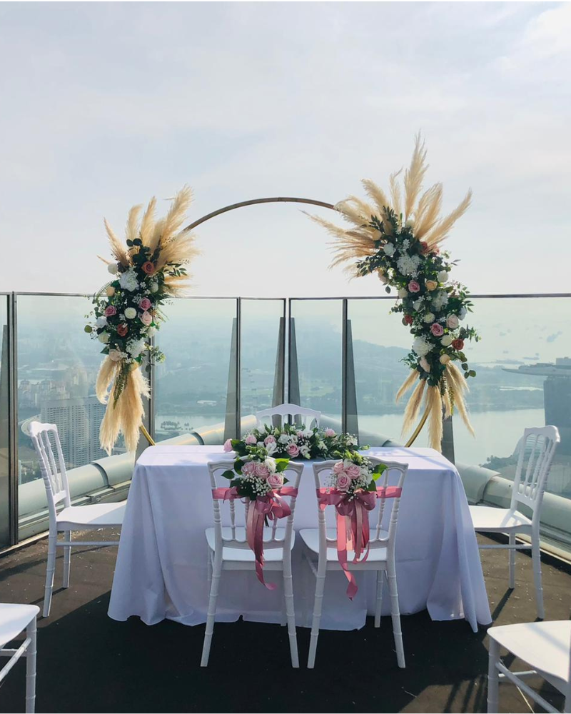 Elegant solemnisation table and floral backdrop setup