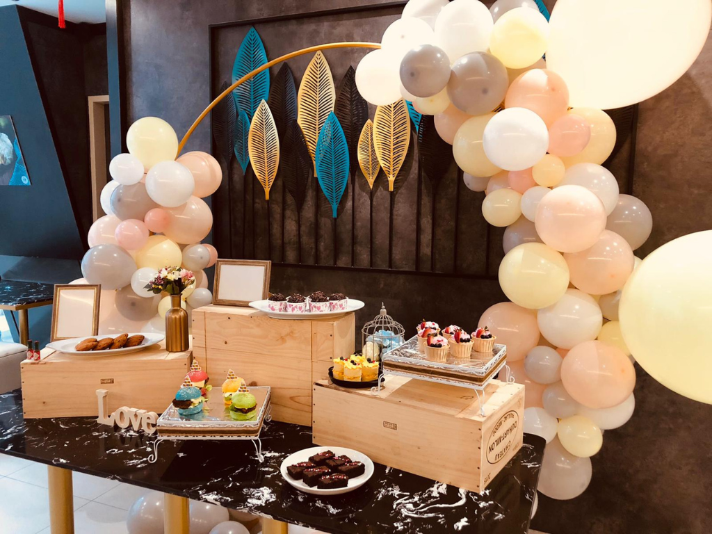 Birthday dessert table decoration with cake stands, props and coordinated styling