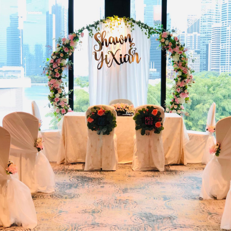 Floral solemnisation setup with personalised backdrop