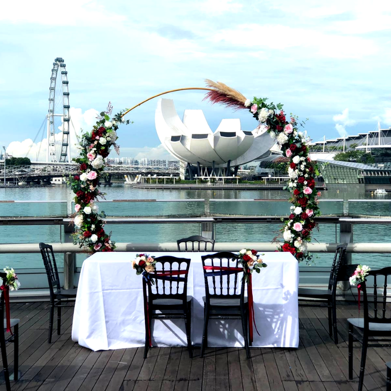 Modern solemnisation setup with floral arch