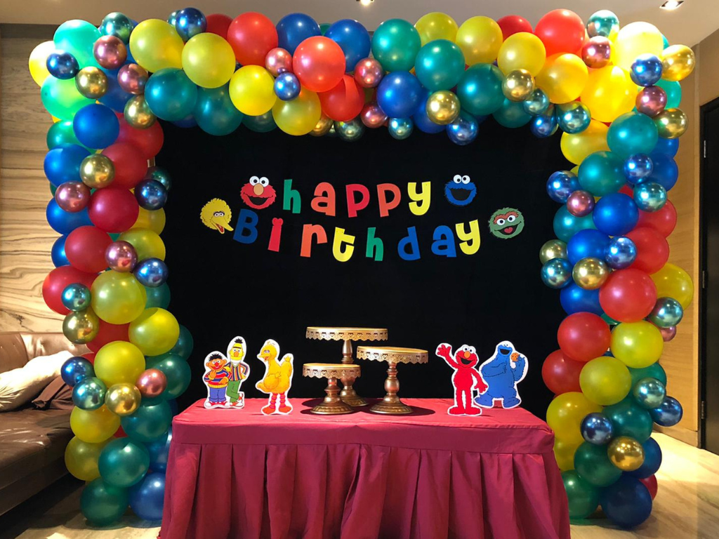 Children's themed birthday party decoration with balloons and customised backdrop