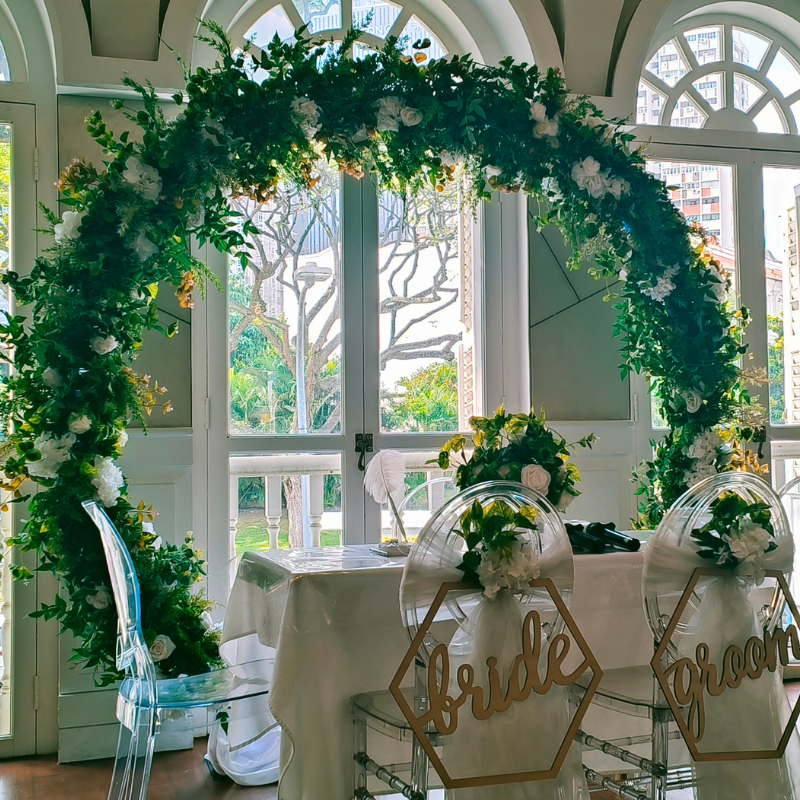 Classic solemnisation setup with greenery arch